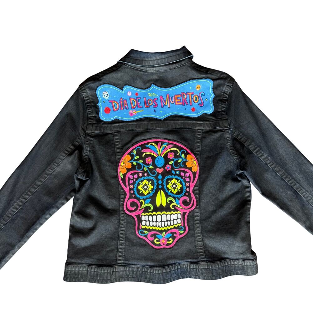 Custome denim jacket featuring a "Día de los Muertos"sugar skull design on back